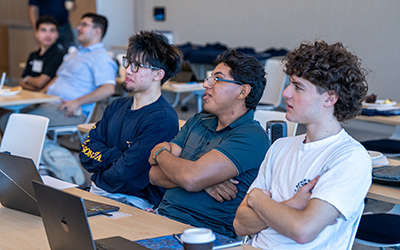 Three students Listening to a presentation