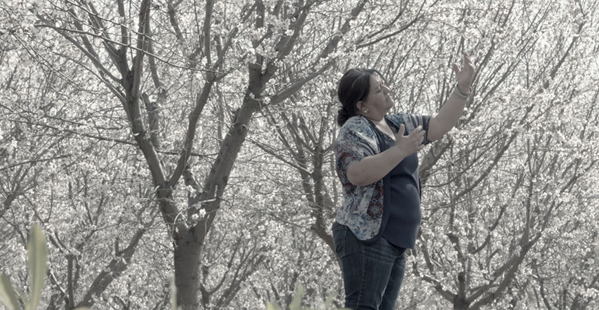 Local activist Ana María Fabián Lomelí is seen in a field.