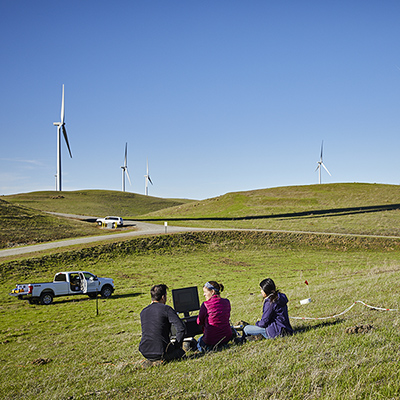 Researchers monitor the compost spreading from their post in the Altamont Hills.