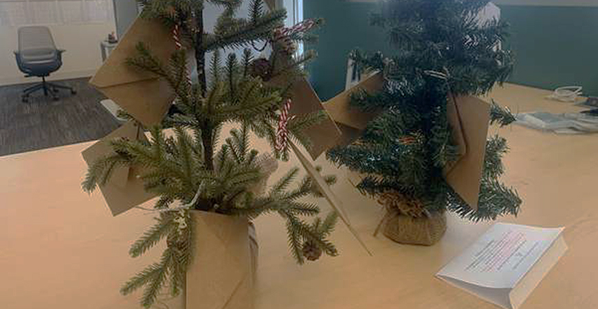 Trees have been placed in four locations for people to select families for whom to buy gifts.